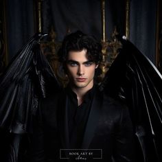 a man in black with wings on his chest