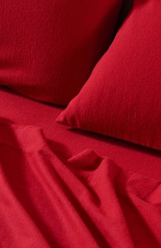 red sheets and pillows on a bed