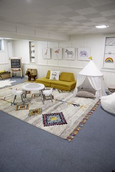 a living room filled with furniture and a white tent in the middle of the room