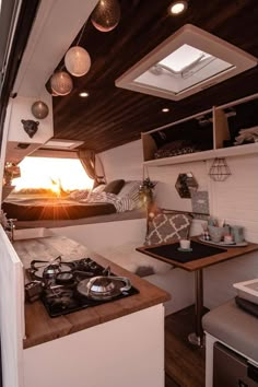 a kitchen with a stove top oven sitting next to a table and microwave in a small room