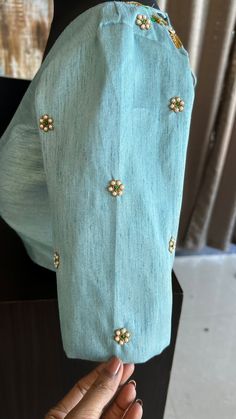 Product Description : Light blue silk blouse comes with heavy detailed and intricate pearl hand works for front & back necks and sleeve as shown. Specification: STITCHED BLOUSE: * Material : Silk * Colour : Light Blue*Blouse length :13-14”(Alterable) * Sleeve Length : 11.5" (Alterable)* Style: Patterned as shown * Works : Threads exclusive detailed and intricate heavy hand works for front & back neck and sleeve as shown. View this post on Instagram A post shared by threadslabel.com (@shobana_nithin) Silk Pattern Blouse Designs, Pastel Blue Blouse Designs, Light Work Blouse Designs, Blue Colour Maggam Work Blouses, Sleeves Work Design For Blouse, Light Blue Blouse Designs, Blue Blouse Aari Work Designs, Brooch Work Blouse Design, Pearl Work Blouses