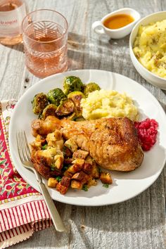 a white plate topped with meat, potatoes and broccoli