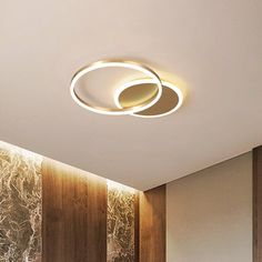 the ceiling light is mounted on the wall in the room with wood paneling and white walls