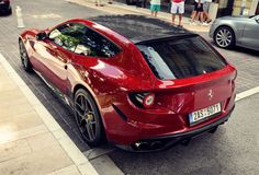 a red sports car is parked on the street