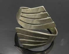 MEXICO 925 Sterling Silver - Vintage Modernist Bypass Cuff Bracelet - BT7295  MEXICO 925 Sterling Silver - Vintage Modernist Bypass Cuff Bracelet - BT7295  Jewelry Type:         Bracelet   Metal Type:            925 Silver  Metal Size:             6.5" Length   2.75" Height   Stone Type:            N/A  Condition:              N/A  Jewelry Weight:     90.8 Grams  PLEASE NOTE: THIS ITEM IS PRE-OWNED. ALTHOUGH MOST ITEMS ARE IN VERY GOOD CONDITION, SOME MAY NEED CLEANING AND/OR MINOR REPAIRS. WE M Bracelet Metal, Metal Bracelets, Antique Rings, Womens Jewelry Bracelets, Arm Band, Cuff Bracelet, Beautiful Rings, Beautiful Necklaces, Types Of Metal