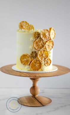 a white cake with orange slices on it