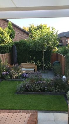 a small garden is shown with wooden benches