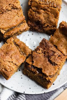 several pieces of brownies on a white plate