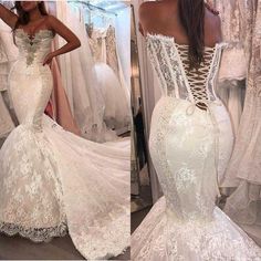 the back of a white wedding dress with lace on it