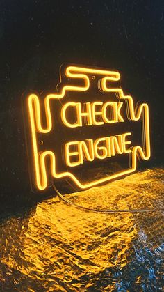 a neon sign that says check engine on it