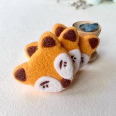 a pair of yellow and brown animal slippers on top of a white tablecloth