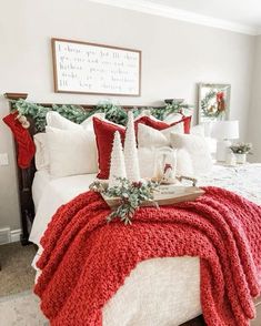 a bedroom decorated for christmas with red and white decor