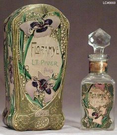 an old fashioned perfume bottle next to it's box