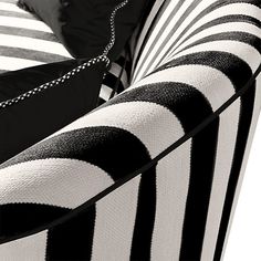 a black and white striped couch with chains on it's armrests is shown