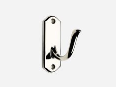 a metal hook on the side of a white wall with a black and silver handle