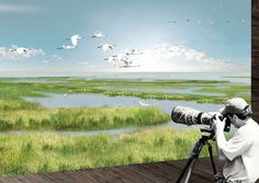 a man with a camera is looking at birds in the sky over water and grass