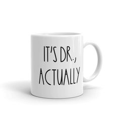 a white coffee mug that says it's dr, actually