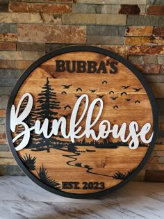 a wooden sign that says burba's bunkhouse on the side of a brick wall