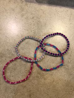 three bracelets sitting on top of a table