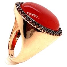 Discover this magnificent signet ring in 18-carat pink gold, featuring a superb cabochon of red onyx, topped with a dazzling brown zirconia. This French ring is a true masterpiece of craftsmanship, combining elegance and timeless style. The red onyx cabochon is the centerpiece of this ring, lending an aura of serenity and relaxation to the wearer. Its deep, haunting color adds a touch of mystery to your appearance, while soothing restless souls. Whether worn on the little finger, ring finger, mi Luxury Oval Cabochon Ruby Ring, Formal Red Domed Rings, Red Domed Gemstone Rings, Luxury Ruby Ring With Oval Cabochon, Elegant Red Dome Ring For Anniversary, Elegant Red Dome Ring For Formal Occasions, Luxury Ruby Ring Oval Cabochon Polished Finish, Luxury Ruby Ring Oval Cabochon With Polished Finish, Luxury Ruby Ring With Oval Cabochon And Polished Finish