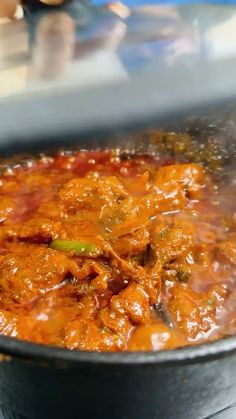 a pot full of food sitting on top of a stove