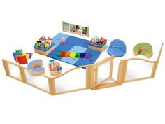 a wooden table and chairs with toys on it