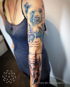 a woman with a bear tattoo on her arm