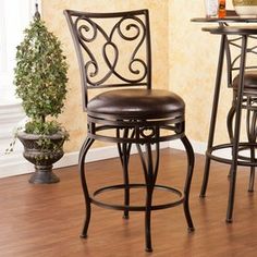 an image of a bar stool in the corner with a table and chairs behind it