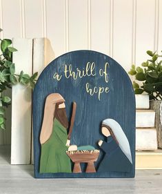 a wooden nativity scene with a baby jesus in the manger and an adult