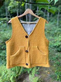 "The Villager is inspired by old world utility, with a longing for simpler times. The Villager is perfect for hikes, homesteading and alleluias. Handcrafted to last and to feel both beautiful and durable.  The Villager is a boiled wool vest with a linen interior.  It has a regular fit and hits at upper hip.  The Villager is a gender neutral garment.  If you don't see your size here, please contact me with your measurements for a custom fit.  Size Chart: X Small - 31\" bust Small - 33\" bust Medium - 35\" bust Large - 37\" bust X Large - 39\" bust Special Care Instructions: Wool is self cleaning and does not require machine washing. If soiled to the point of needing more than an air out, please hand wash in color water and gentle detergent. Do not agitate or squeeze. Air dry only." Boiled Wool Vest, Wool Vest Outfit, Wool Vest Women, Linen Vest, Linen Interior, Simpler Times, Color Water, Brown Vest, Making Stuff