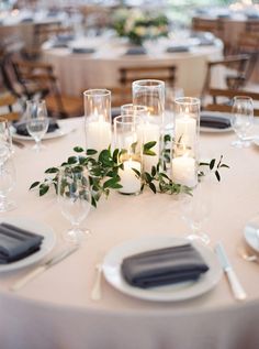 the table is set with candles and place settings