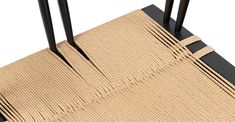 an area rug with two black poles sticking out of the top and one on the bottom