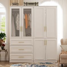 a large white closet with clothes hanging on it's doors and two chairs in the room