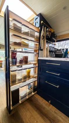 the shelves are filled with various containers and items for storage in the kitchen, along with other things