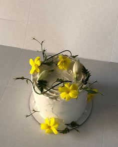 a white cake with yellow flowers on top