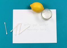 two lemons on top of a piece of paper next to some toothpicks