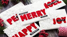 three christmas cards with the words be merry and joy on them, surrounded by holiday decorations