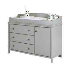 a baby crib with drawers and changing table