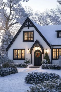 Snow-covered Tudor house with warm lights glowing. The charming fusion of history and contemporary flair in modern Tudor houses can transform your living space from “just nice” to “royalty-approved.” Tudor Ranch House Exterior, Small Tudor Style Homes, Contemporary Tudor, Transitional Tudor, Tudor Houses, Tudor Homes, Cottage Houses, Meridian House, Falling Water House