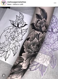 a woman's arm with black and white flowers on the left side of her forearm