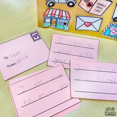 three pink post it notes sitting on top of a table next to some magnets