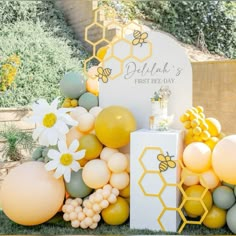 a bee themed birthday party with balloons and honeycombs