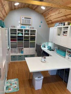 a room with lots of storage space and furniture in the center, including a desk