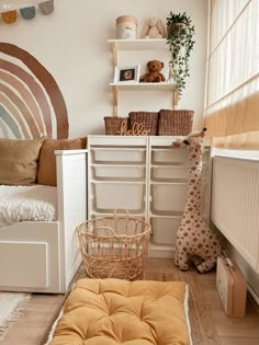 a bedroom with a bed, dresser and toy chest in it's corner next to a window