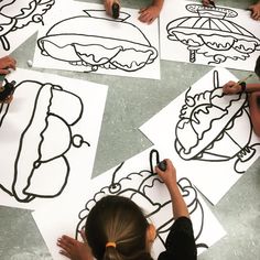 children are drawing food on paper with scissors