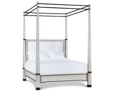 a four poster bed with white linens and black metal frame, against a white background