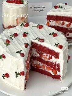 there is a cake with strawberries on it and two slices missing from the cake