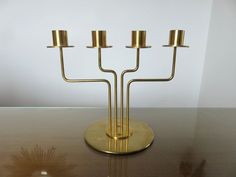 a brass candelabra with four candles on it