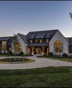 a large house with lots of windows and landscaping