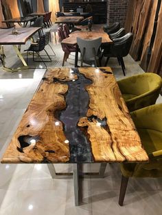 the table is made out of wood and has black veining on it, along with yellow chairs